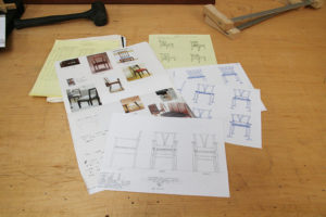 Commissions process - initial sketches and inspiration images on table